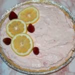 no bake strawberry lemonade pie garnished with lemons and strawberries