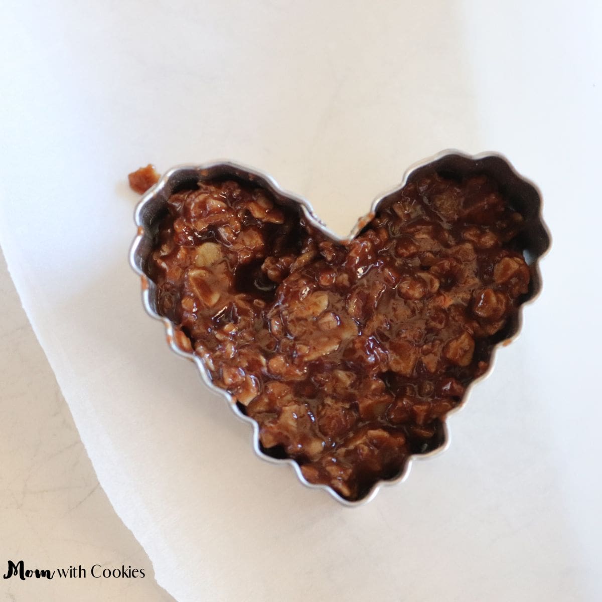 a 1 inch heart shaped cookie cutter around a no bake cookie