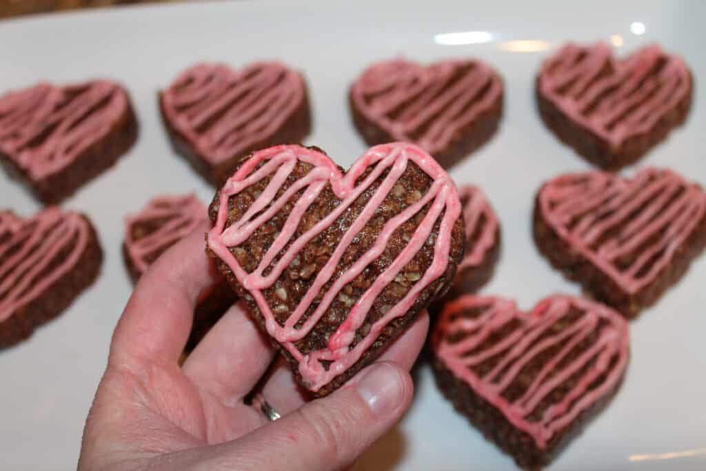 holding a heart shaped no bake cookie