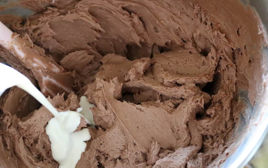 pouring heavy cream into the mixing bowl