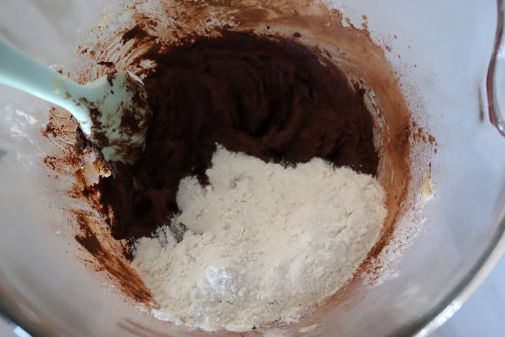 adding flour to the mixing bowl