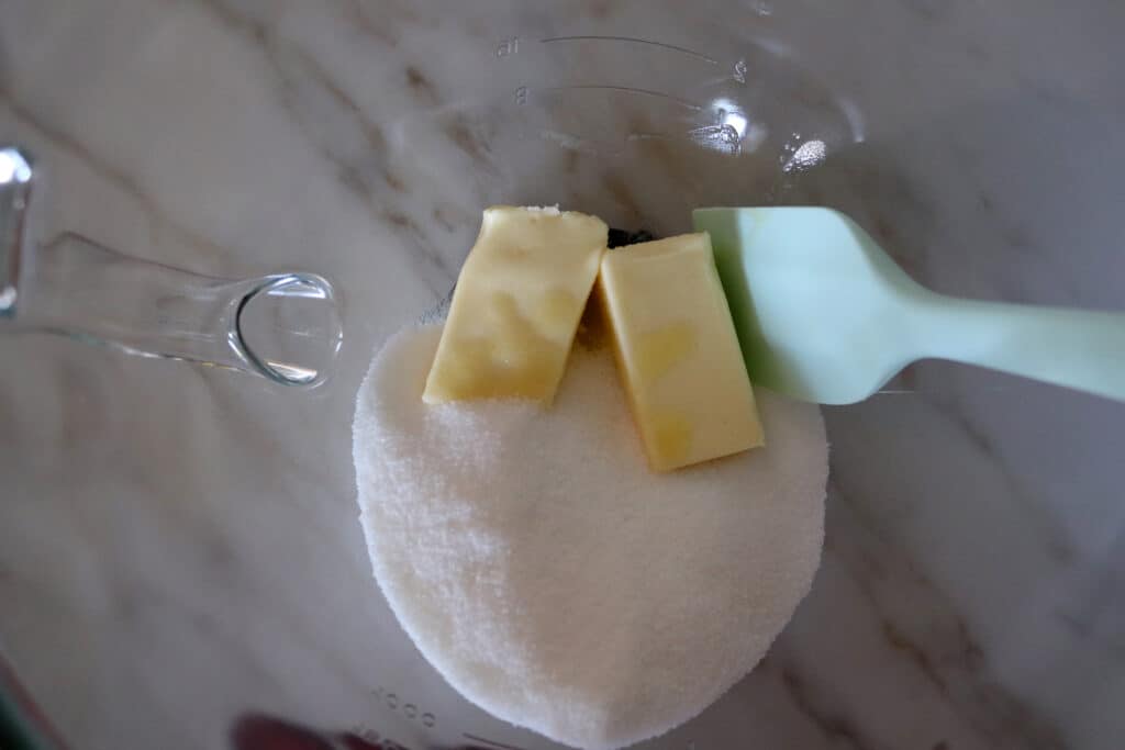 a mixing bowl with butter and sugar