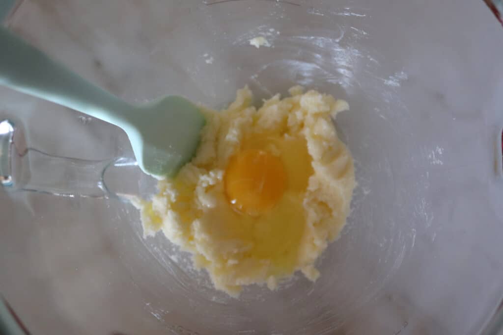 egg added to the mixing bowl with the creamed butter and sugar