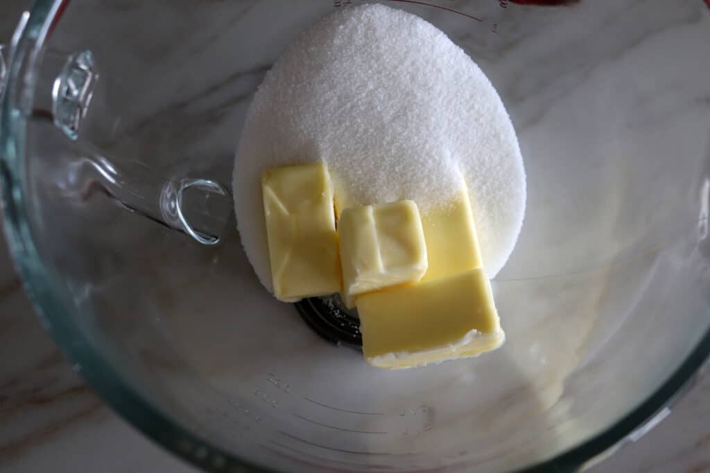 a mixing bowl with butter and sugar