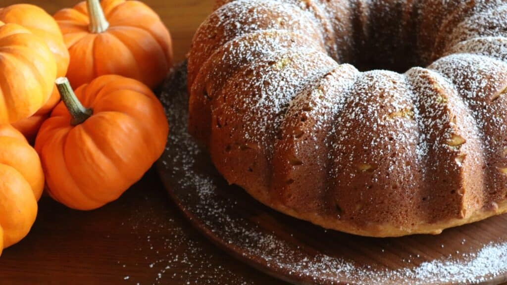 pumpkin spice bundt cake made from scratch with lightly sprinkled powdered sugar on top