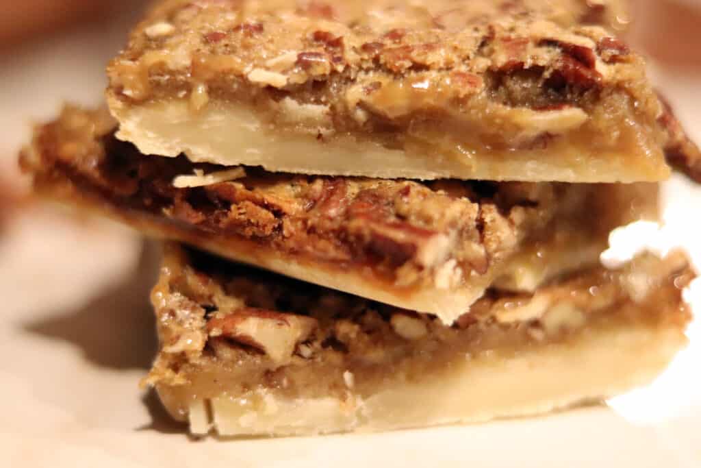 pecan pie bars stacked on top of each other