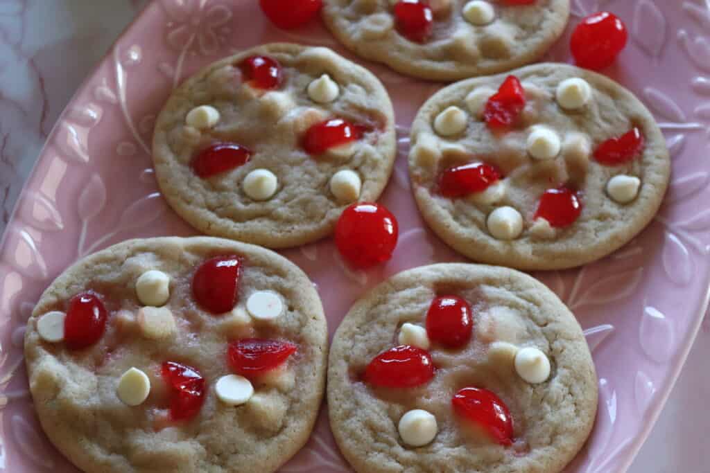 a plate of white chocolate cherry cookies freshly baked