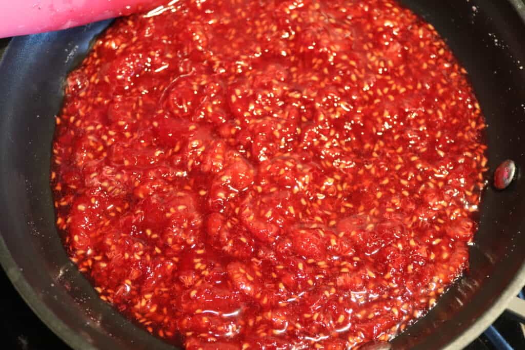 crushed raspberries in frying pan