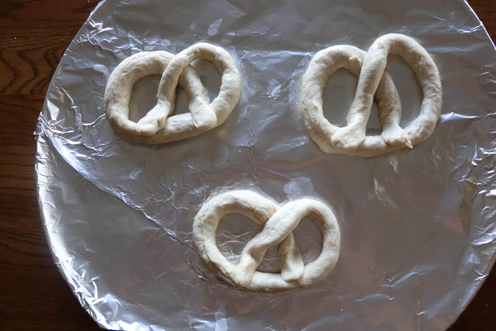 soft pretzel dough formed into pretzel shape