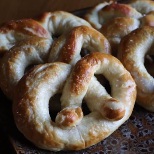 a bunch of homemade soft pretzels on a plate