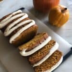 homemade pumpkin bread sliced with brown butter frosting on top