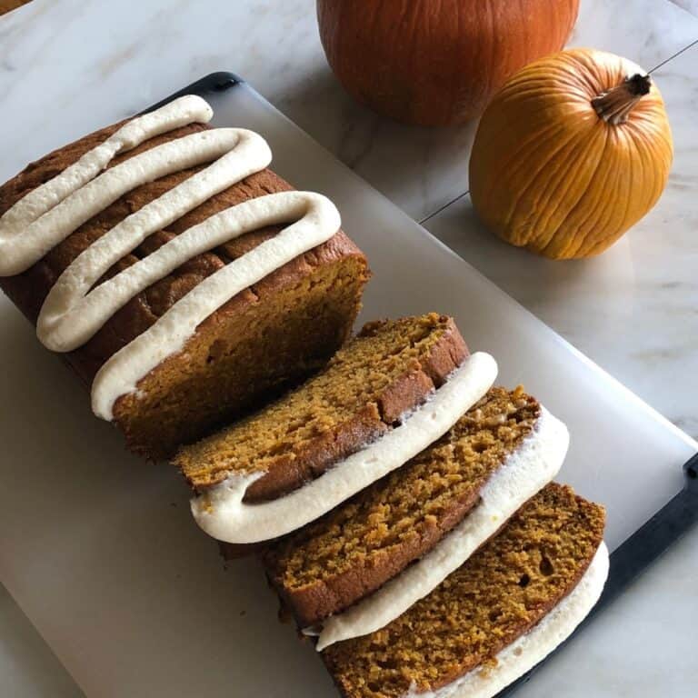 homemade pumpkin bread sliced with brown butter frosting on top