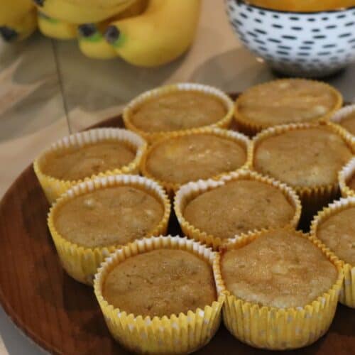 homemade pineapple banana muffins on a plate with bananas in the background