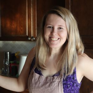 Joanna Stephens in her kitchen wearing an apron