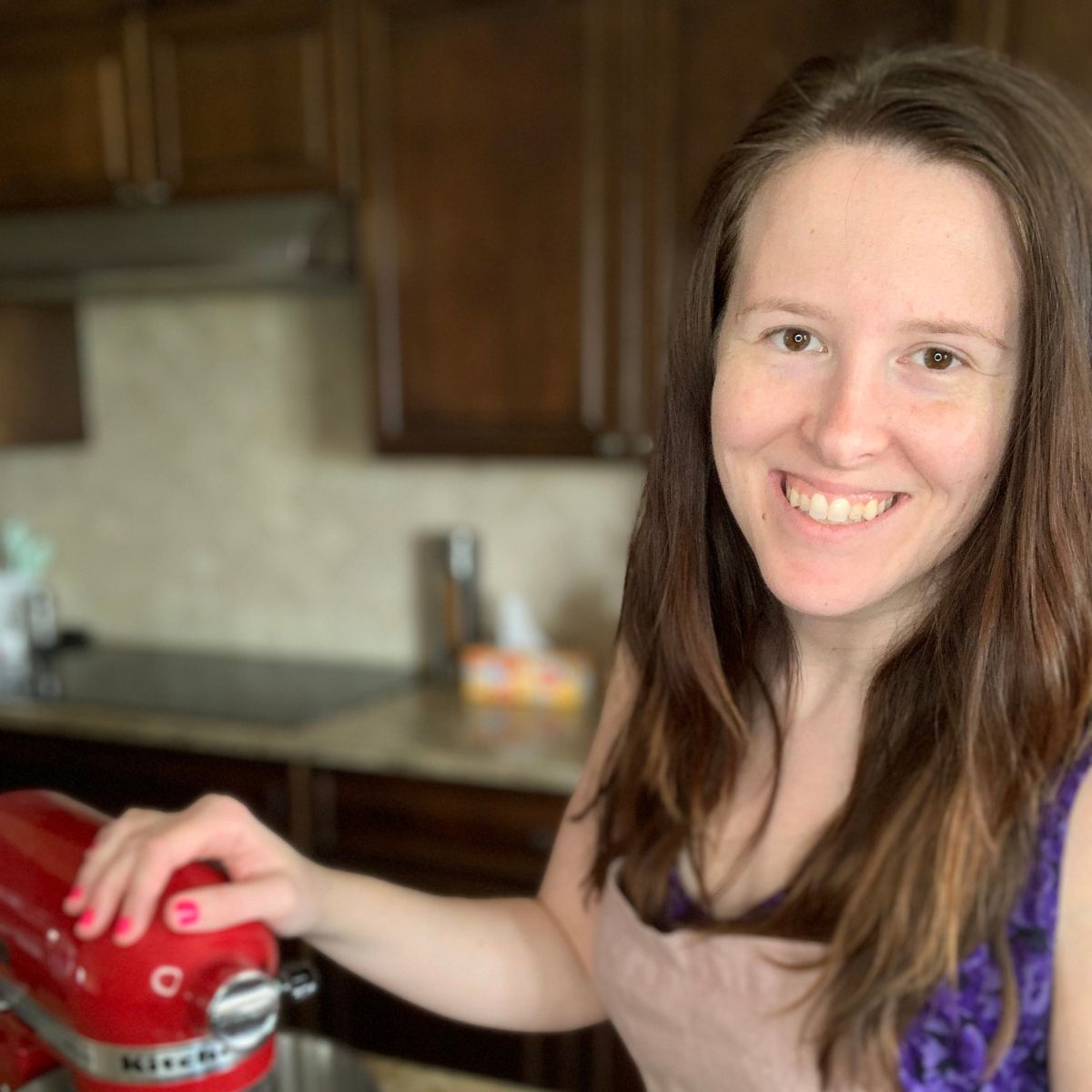 Joanna Stephens standing by a kitchenaid mixer